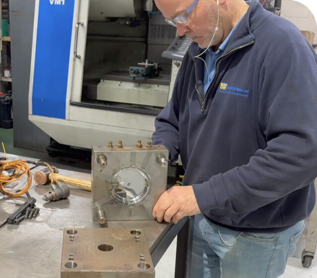 factory worker assembling mould tool